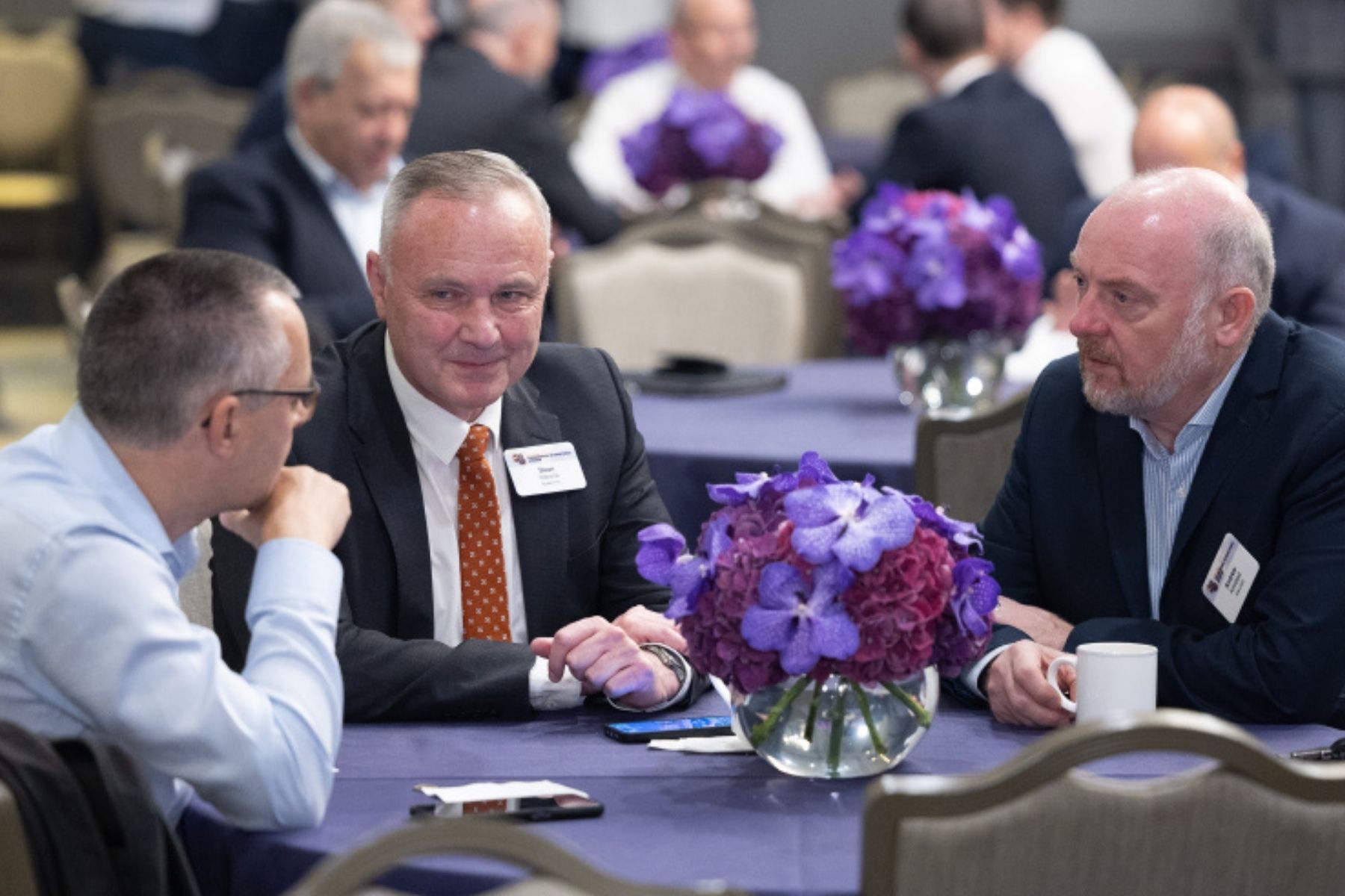 People sitting around table at ISTAT at the Farnborough International Airshow.